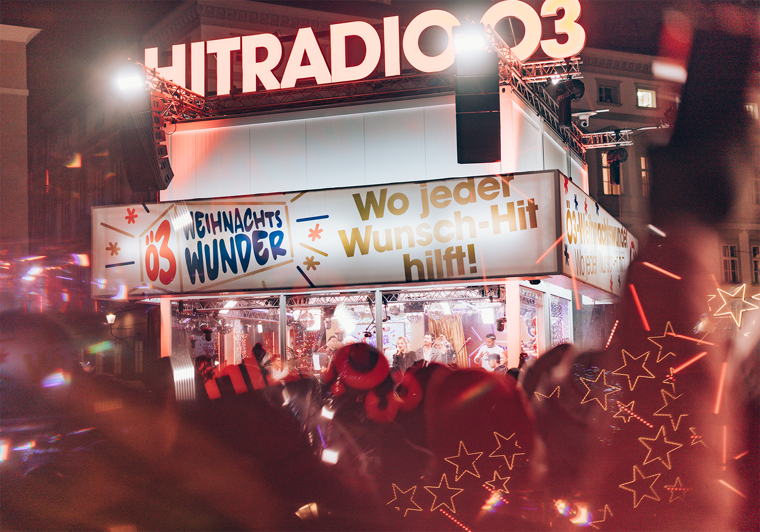 Live performance on a Christmas stage; banner