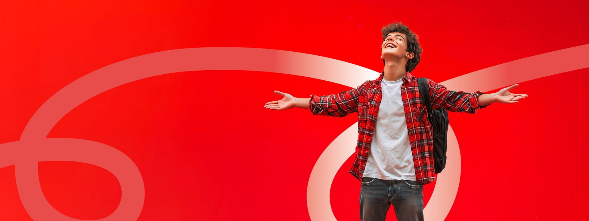 Joyful young man in a red plaid shirt with backpack spreads arms against a red backdrop.